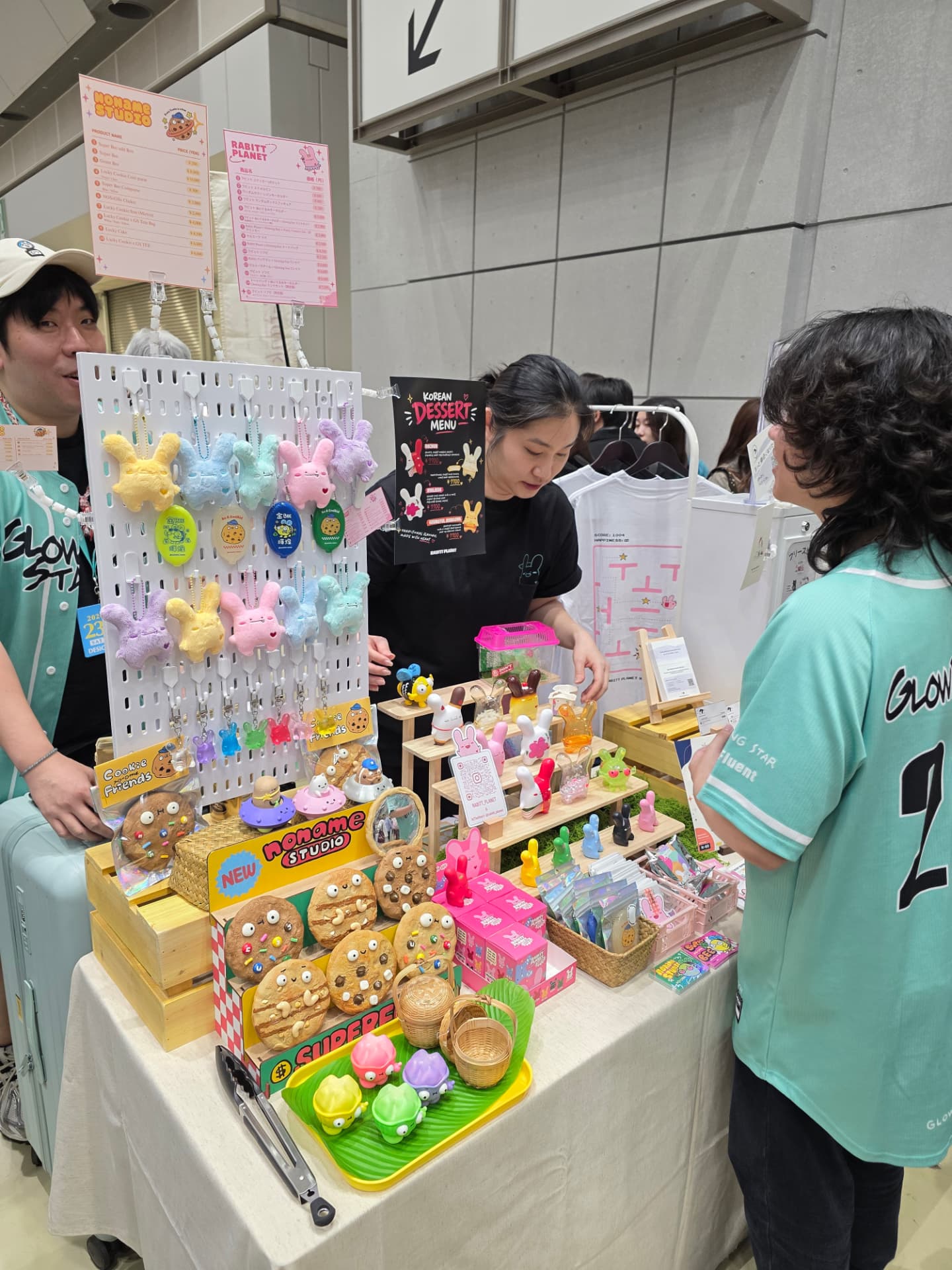 The Glowing Star shared booth at Design Festa Vol. 63, seen from the aisle: the Rabitt Planet and noname studio table with plush charms, cookies and figures