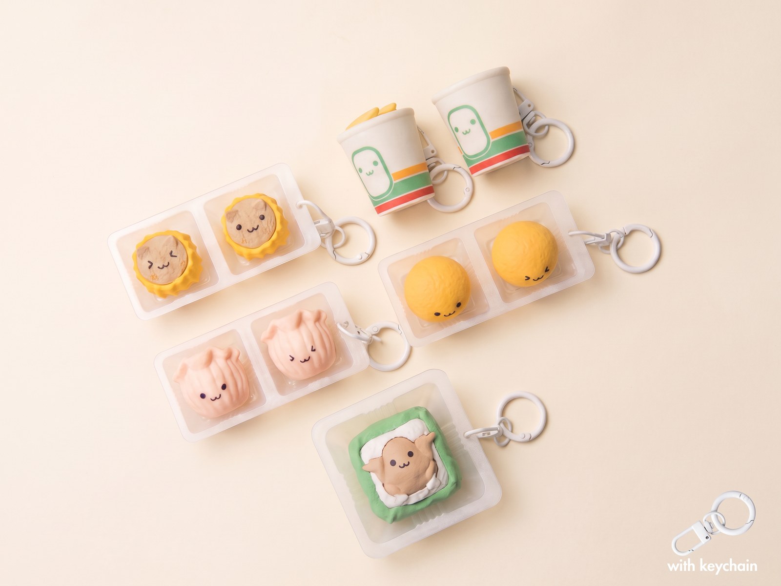 7-Eleven Hong Kong Snack Blind Box clicker keychains: miniature drink cups, siu mai, har gow, buns and matcha toast in translucent trays on a cream background