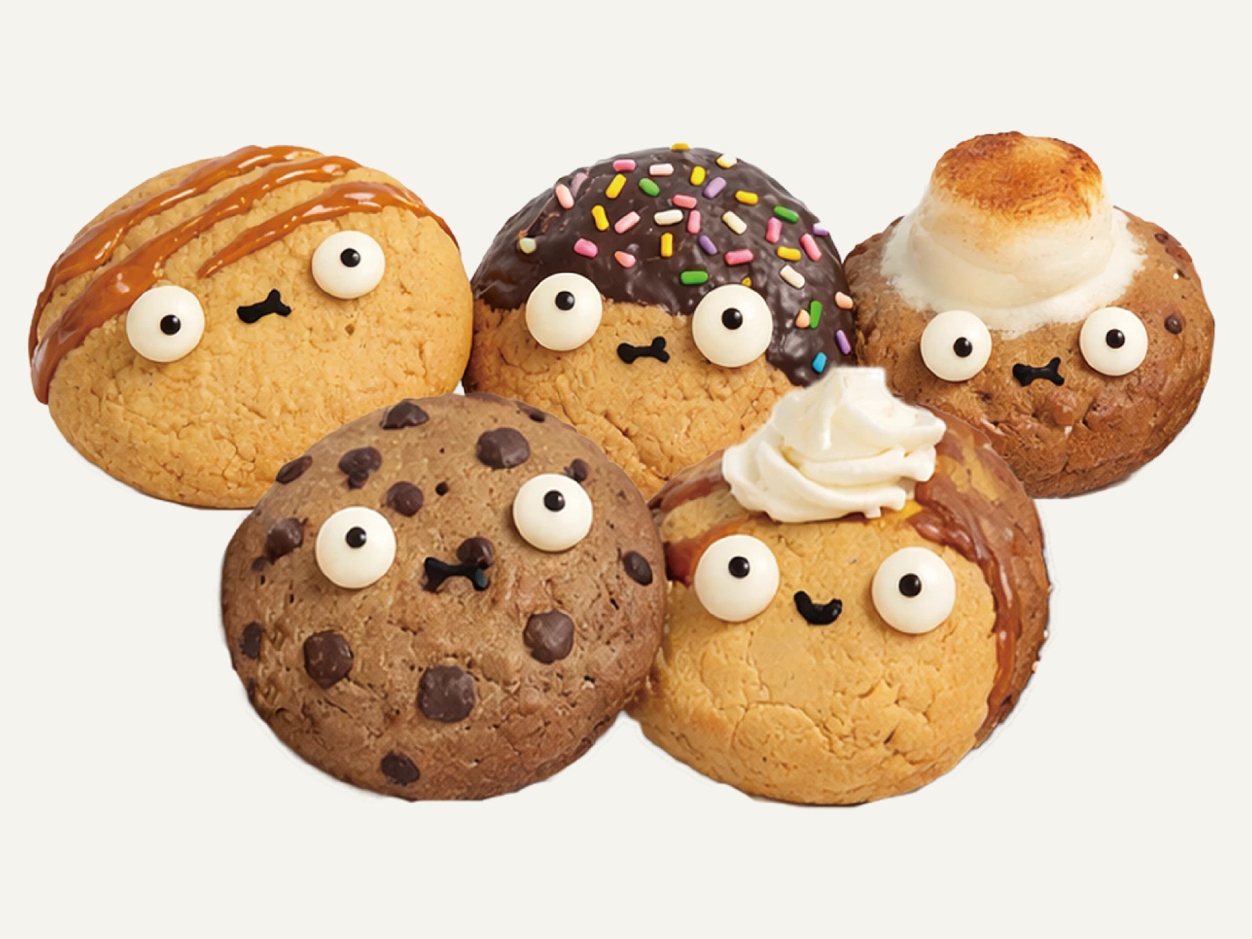 Five Soft Cookies characters with candy eyes and different toppings, caramel drizzle, chocolate and sprinkles, toasted marshmallow, chocolate chips and whipped cream, arranged in a cluster