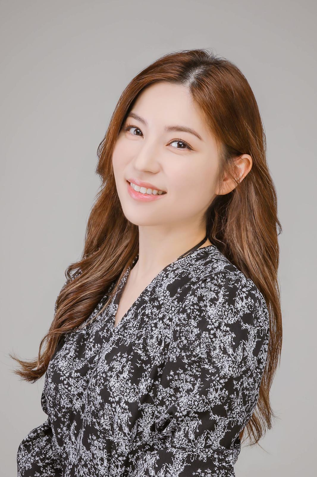 Studio portrait of Christy Yeung against a neutral grey background